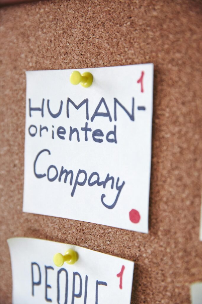 Handwritten notes on a corkboard illustrating a human-oriented company concept. Ideal for business innovation themes.